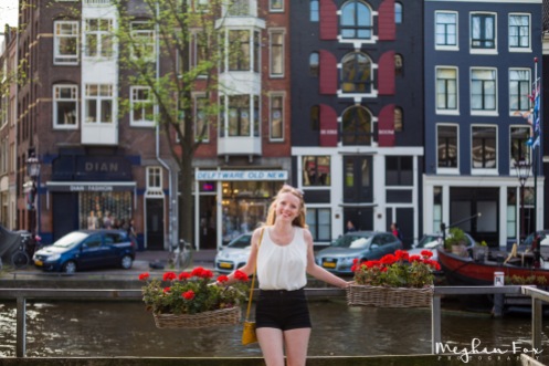 flowers, bright buildings, and a canal = Amsterdam